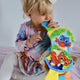 Jucarie din plus, Playgro, Clip Clop, Carticica tactila, Stimuleaza dezvoltarea senzoriala, Cu inele pentru dentitie, Cu diverse forme si texturi, 3 luni+, Musical Clip Clop Teether Book