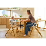Scaun de masa multifunctional Celia, Lionelo, Din lemn de fag, 6 luni- adult, Reglabil pe inaltime, Spatar lat, Sezut ergonomic, Tavita silicon, Suport de picioare reglabil, Greutate maxima 90 Kg, Alb/Natural